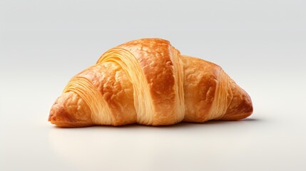  a croissant with a bite taken out of it's center is sitting on a white surface in front of a white background.