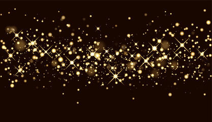 Christmas glitter background. Shining gold sparkles. The glitter of golden dust in the rays of light. Abstract festive background in dark brown color