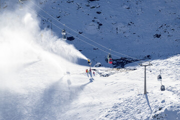 snow cannons, spreading snow on the slopes next to the cable cars in sierra nevada ski resort