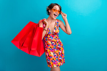 Photo of crazy funny woman with bob hairdo dressed colorful clothes hold new outfit touch sunglass...
