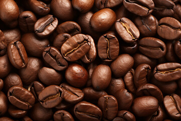 Close-up of roasted coffee beans on a backdrop.