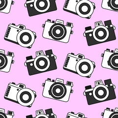 Bright seamless pattern of three black and white cameras of different shapes on a pastel pink background. Doodle retro film camera, wrapping paper, background.