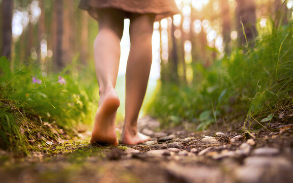 Woman walks with bare feet on a forest path, AI generated