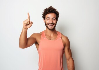 portrait of a expression of a happy surprise mansport man sportwear tanktop, against white background who holds her index finger up to explain or point, 