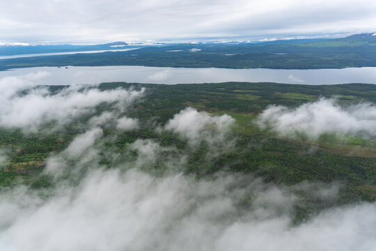 Aerial view of clouds and shore line of Six Mile Lake, between Lake Clark and Lake Iliamna in Alaska. Near Nondalton, Mud River, Newhalen River, Pickerel Lakes.