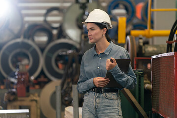 Metalwork manufacturing factory inspection, female engineer inspector with safety equipment conduct...