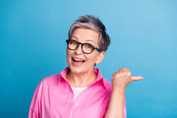 Photo of impressed woman dressed pink shirt in glasses directing at unbelievable sale empty space...