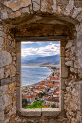 Paralio Astros through a ruined window of the medieval fortress, in Peloponnese Greece