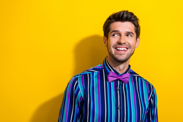 Portrait of pleasant nice guy dressed stylish shirt bow tie look at proposition empty space isolated on bright yellow color background