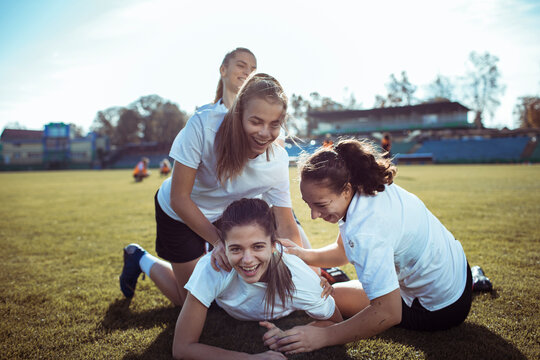 Team, success and winner by female soccer player celebration during game at football field
