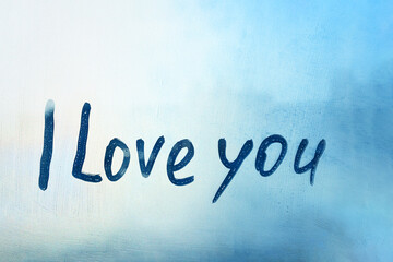 avowal words I love you on foggy glass on blue window