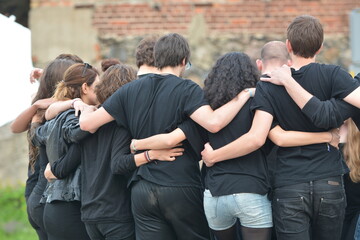 Young people hugging together and dancing