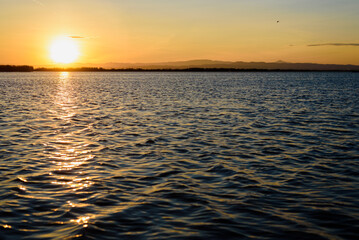 Rippled water of a lake at sunset, natural background.