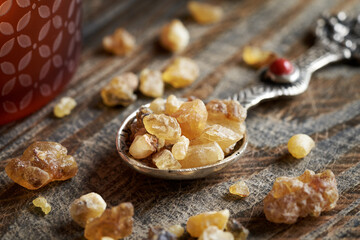Frankincense resin crystals on a spoon