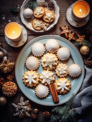 Tasty homemade Christmas cookies on a table, top view. Gingerbread with powdered sugar on a plate.