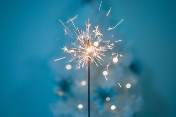 Beautiful sparklers made of sparklers on a New Year's bokeh background, on a blue background,...