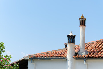 Tiled light brown roof with chimney stacks