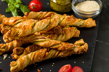 Bread sticks with sesame and tomato with pesto sauce