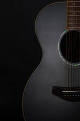 Classic acoustic guitar close up isolated on black background