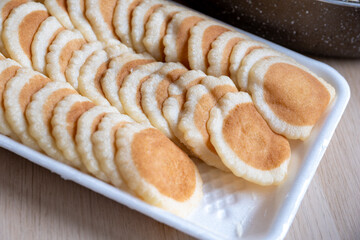 Qatayef plate ready to be filled and stuffed on wooden table