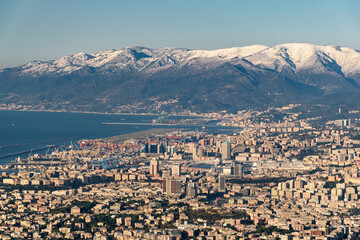 Panoramic winter view of Genoa with surrounding mountains in the background