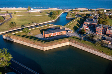 Wall and Earthen Bastion at Fort Monroe With a Building Behind the Fortress and Bay in the...