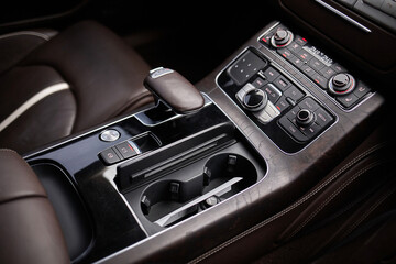 Shift lever, car steering wheel and sensors. Inside a modern car view, city car interior background