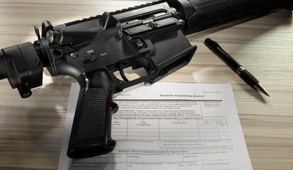 Assault rifle with pen and public domain background check form - obrazy, fototapety, plakaty