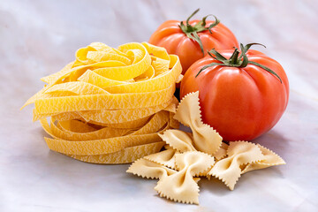 Pasta tagliatelle and tomatoes close-up