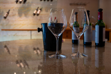 Tasting of red dry Saint-Emilion wine aged in French oak wooden barrels in cellar, Saint-Emilion...