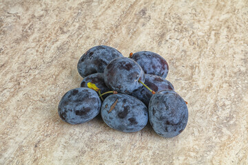 Ripe plum heap over background