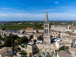Fototapeta premium Aerial views of green vineyards, old houses and streets of medieval town St. Emilion, production of red Bordeaux wine on cru class vineyards in Saint-Emilion wine making region, France, Bordeaux
