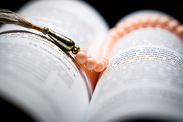 close up of an book with a rosary