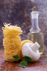 Homemade pasta pasta, mushrooms, oil and parsley isolated on white
