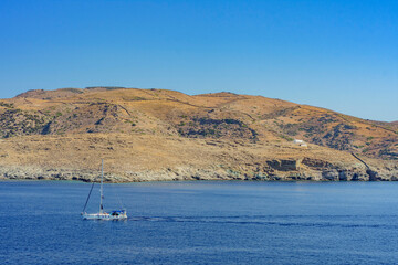 Sailing boat sails between the Serifos island coasts, Greece - 683539560