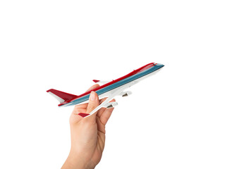 Hand holds a toy airliner ready to fly