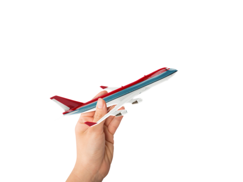 Hand holds a toy airliner ready to fly