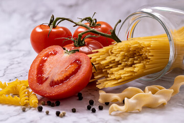 Whole spaghetti, bunches of tomatoes