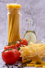 Whole spaghetti, bunches of tomatoes