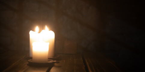 Tranquil Glow: Three Candles Illuminating the Darkness