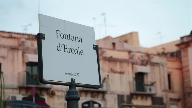 noto sicily italy fontana d'ercole anno 1757 white and black sign writing caption text with building behind