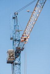 Fototapeta na wymiar Construction tower crane for lifting loads to a height.