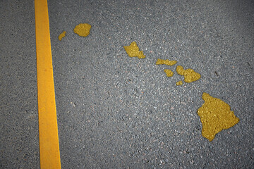 yellow map of hawaii state on asphalt road near yellow line.