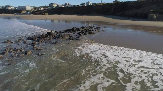 Zoom in gimbal down oblique of Boulder field at Nye Beach, Newport Oregon Video 5