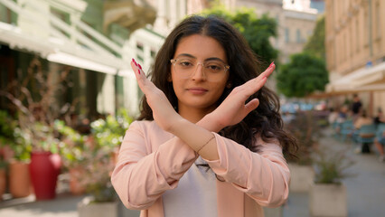 Female portrait young Indian Arabian ethnic woman showing prohibition sign serious businesswoman...