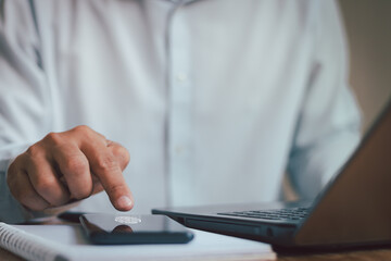 Close up hand of business people pushing button fingerprint sensor on screen of smartphone at desk. UI, UX set for mobile app. Lock, unlock button. Business technology cyber security concept.