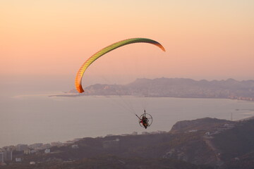 beauty of Paragliding flying, freeflying and powered paragliding in scenic nature aerial...