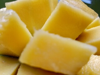 ripe mango that has been cut in half. exotic