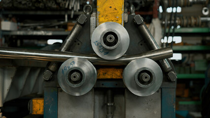 Industrial machine for cold metal pipe bending at industrial hall at manufacturing plant. Creative. Heavy industry concept.