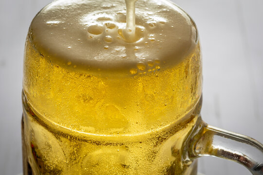 Beer poured in mug with suds